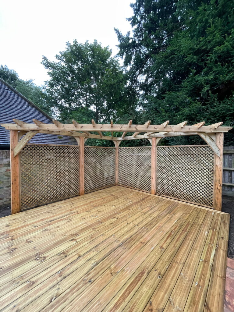 Wooden pergola structure with beautiful lattice walls, surrounded by lush greenery, ideal for outdoor relaxation and gatherings
